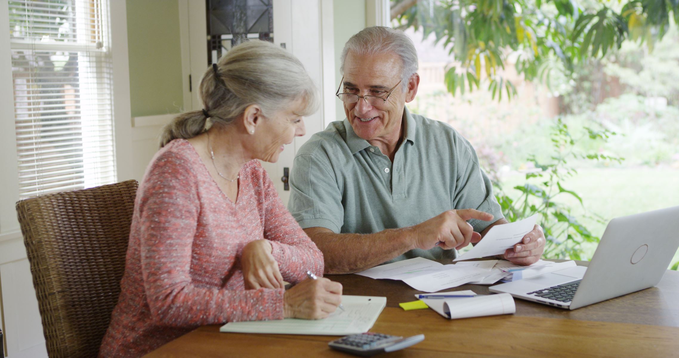 Elderly couple going over bills on computer